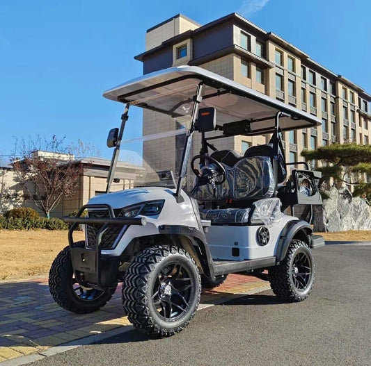 2025 REVO E2X luxury lifted electric golf cart on a sunny day, showcasing its sporty design and rugged tires.